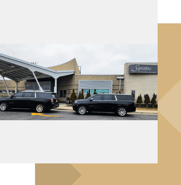 Black SUVs parked outside Signature hangar